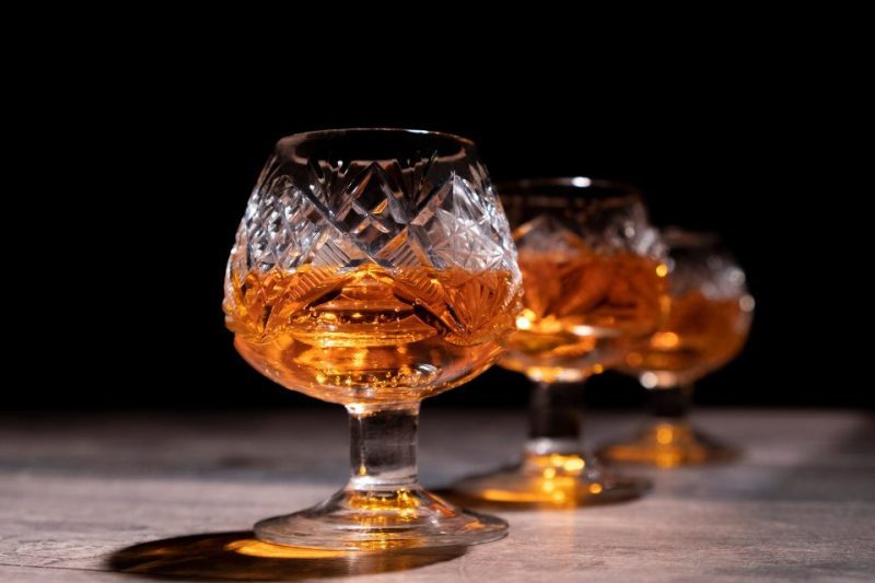 Three bourbon snifters filled with fine bourbon.