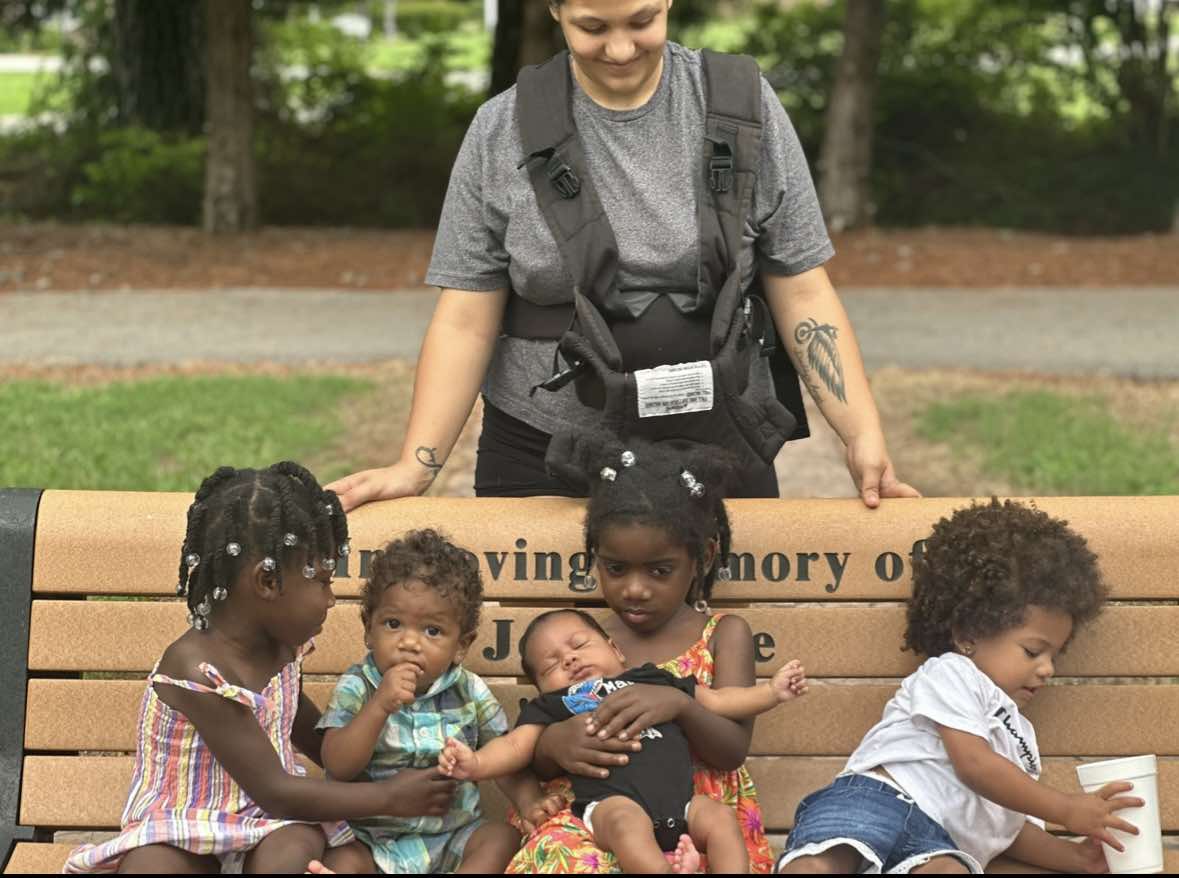 Photo of Rose Stanley looking at her children