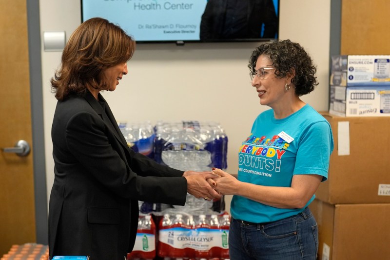 Democratic presidential nominee Vice President Kamala Harris, left, speaks with Angelica Wind, a worker at a food drop-off and distribution center after receiving a briefing on the damage from Hurricane Helene, Saturday, October 5, 2024, in Charlotte, N.C. (AP Photo/Chris Carlson)