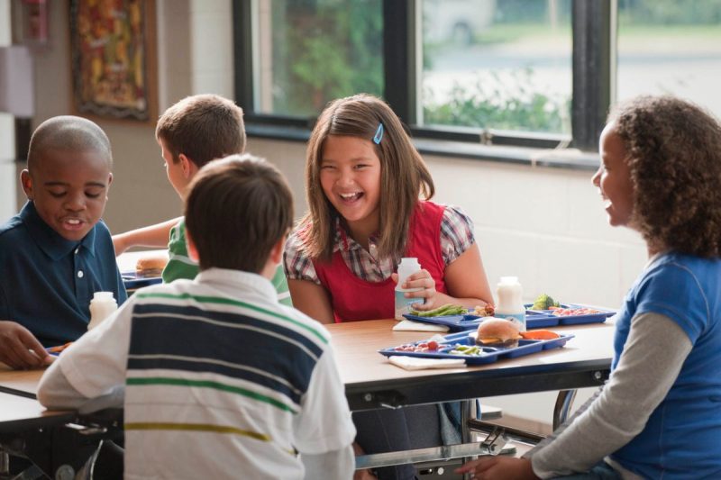 kids having lunch together in a school cafeteria